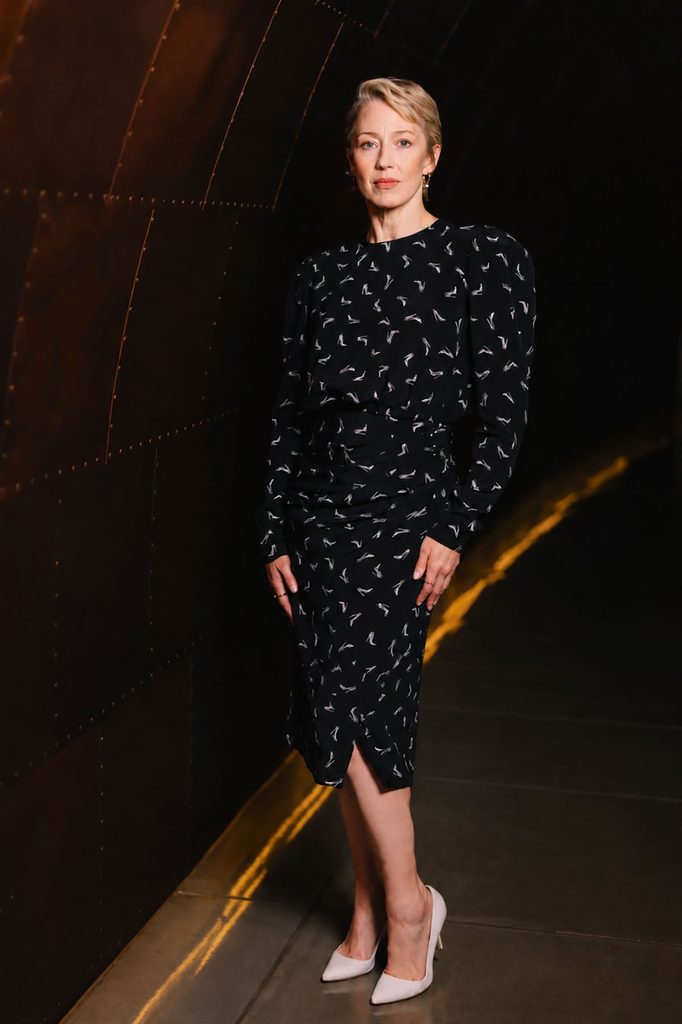 Carrie Coon wearing a black Carolina Herrera Fall 2026 Good Girl shoe-print dress and pale pink pumps at a London film festival Q&A.