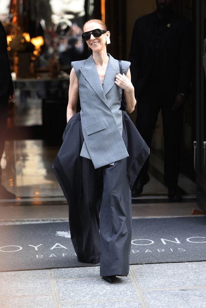 Céline Dion wearing Sarah Burton’s Givenchy Spring 2027 grey jacket and exaggerated trousers in Paris.
