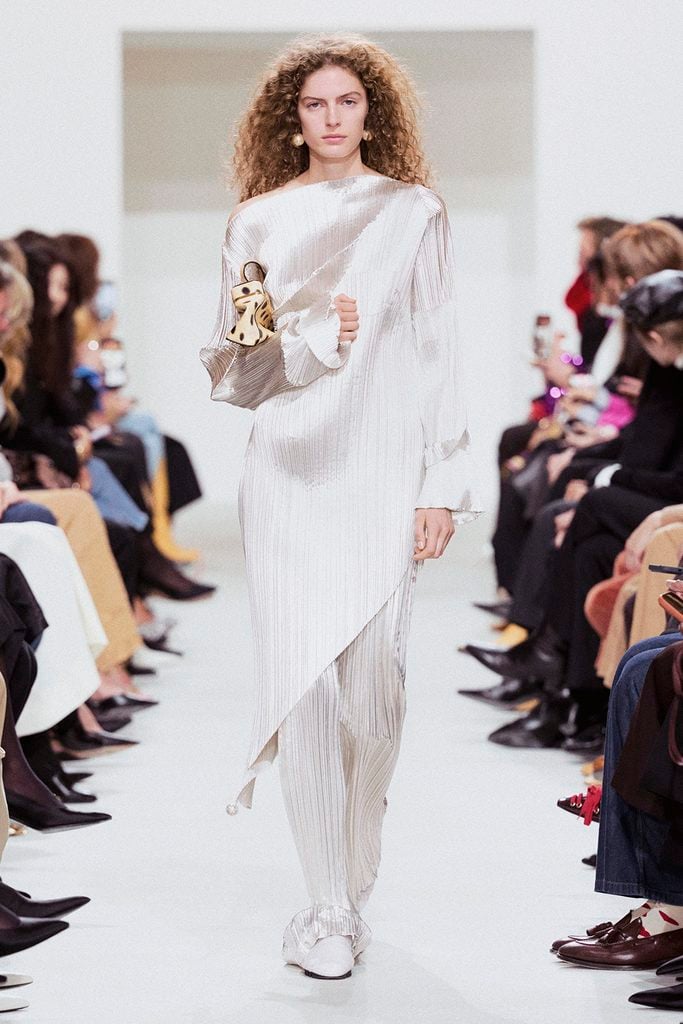 Model wearing the silver pleated tunic and matching column skirt from the Celine Spring 2027 runway collection.