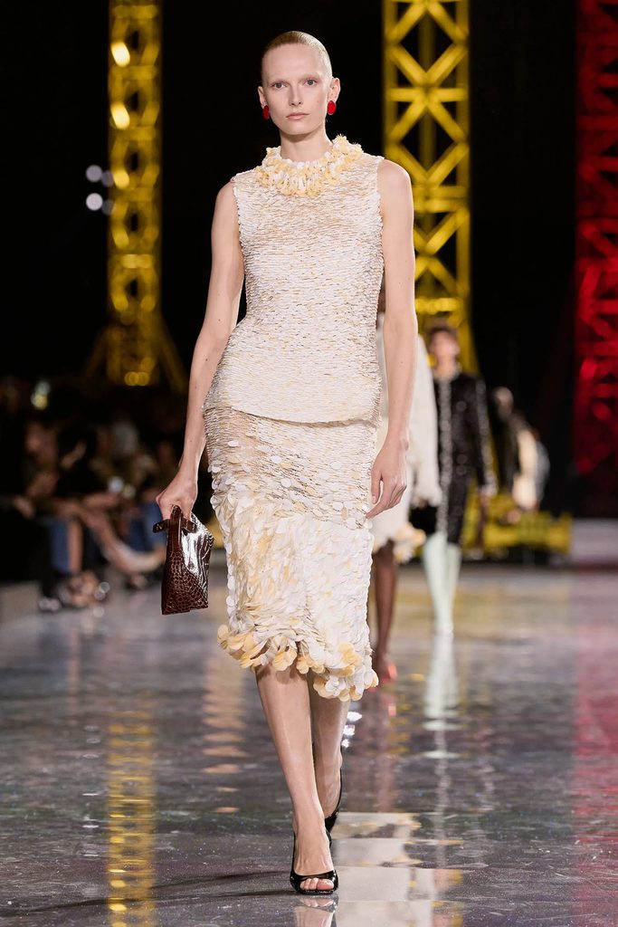 Chanel Fall 2026 white textured sleeveless top and matching midi skirt on the runway.