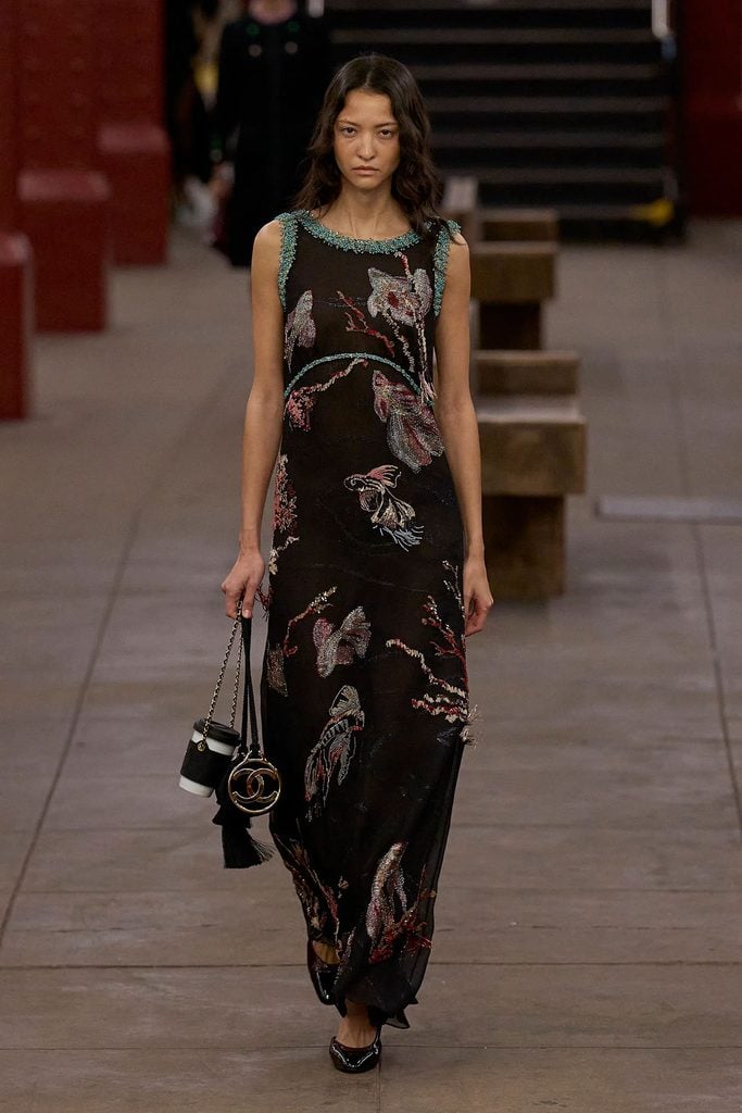 Chanel Pre-Fall 2026 collection reference showing the black embroidered dress with colourful motifs and turquoise beading worn by Bhavitha Mandava at the 2026 WSJ. Magazine Innovator Awards.