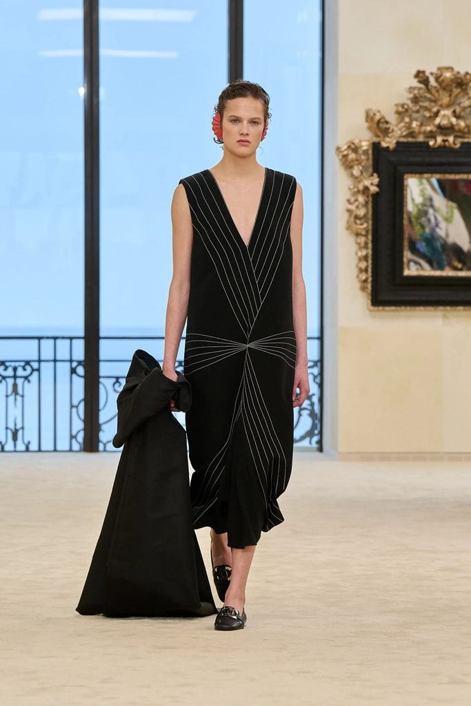 Chanel Resort 2027 collection reference for the black dress with contrasting geometric lines and a plunging neckline worn by Miyako Bellizzi at the 2026 WSJ. Magazine Innovator Awards.