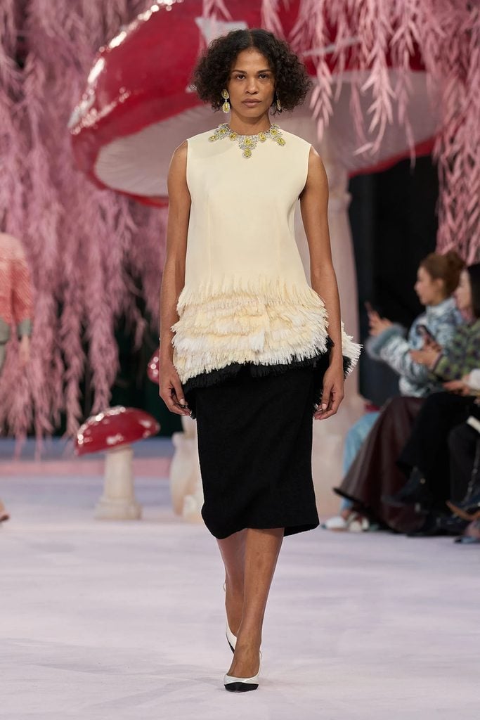 Chanel Spring 2026 Haute Couture runway look featuring an ivory fringed top, black pencil skirt and embellished necklace