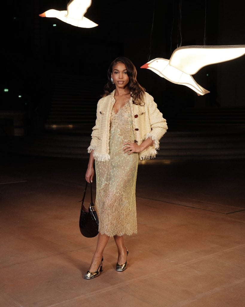 Lori Harvey wearing a Chanel lace dress and textured jacket at the Chanel Spring 2027 show during Paris Fashion Week.