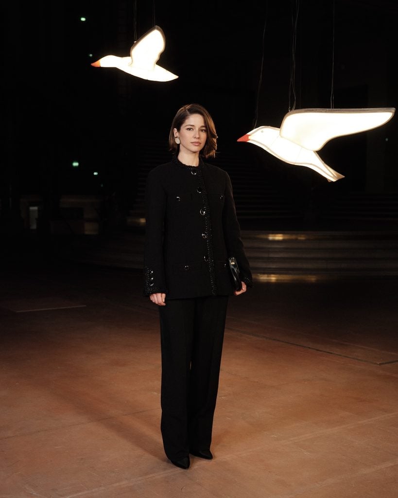 Mariana di Girolamo wearing a black Chanel tweed jacket and trousers at the Chanel Spring 2027 show in Paris.
