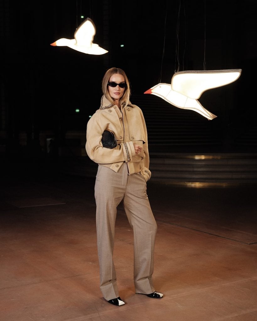 Rosie Huntington-Whiteley wearing a neutral Chanel jacket and tailored trousers at the Chanel Spring 2027 show in Paris.