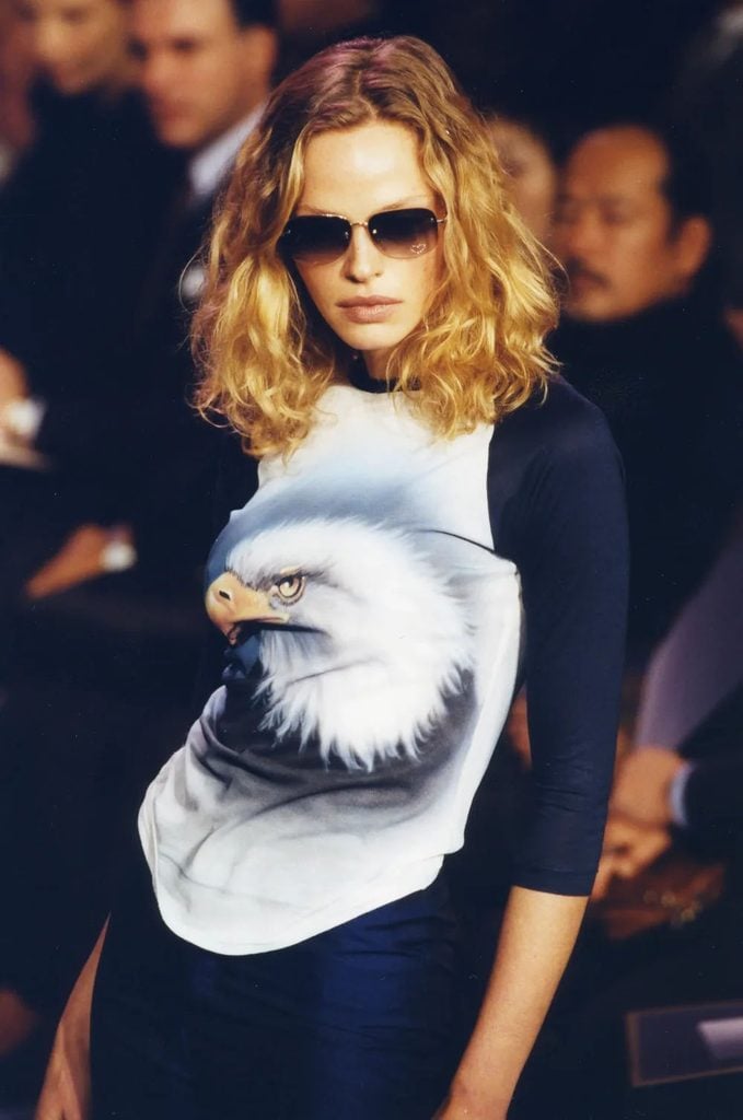 Chloé Spring 1999 runway model wearing an eagle-print top with heart-accented sunglasses from Stella McCartney's collection