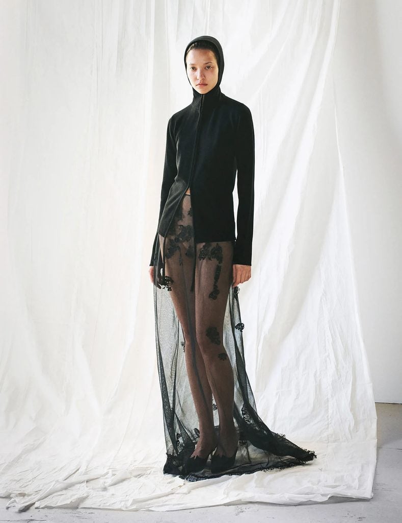 Colleen Allen Fall 2026 collection look featuring a black hooded cardigan and sheer floral-embroidered skirt.
