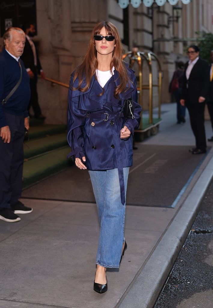 Daisy Edgar-Jones wearing a blue Burberry trench jacket with jeans and carrying a black Burberry Bridle saddle bag in New York.