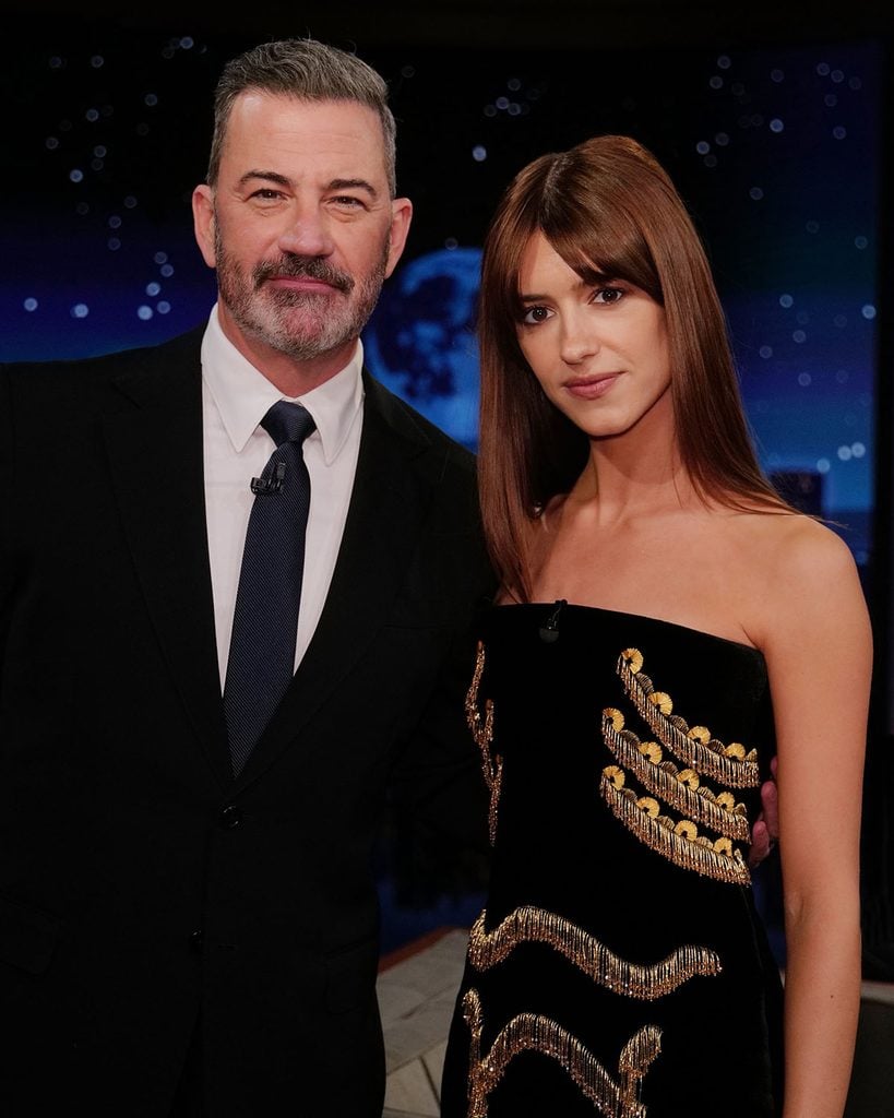 Daisy Edgar-Jones posing with Jimmy Kimmel in her gold-embroidered Schiaparelli bustier dress during her late-night appearance.
