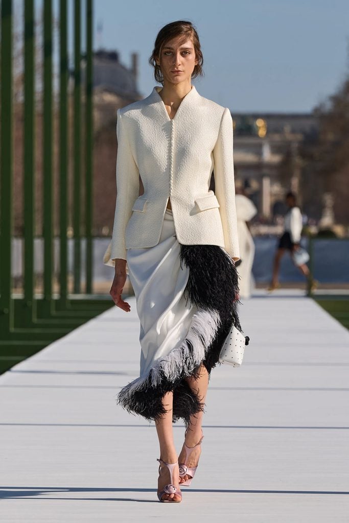 Dior Fall 2026 runway reference for Marisa Abela's ivory tailored jacket and black-and-white feathered skirt worn at the TIME100 Next Gala.