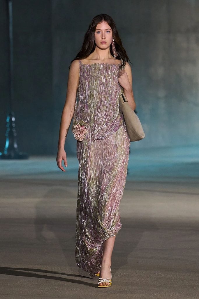 Model wearing the embroidered pink-and-gold draped dress from the Dior Resort 2027 collection.