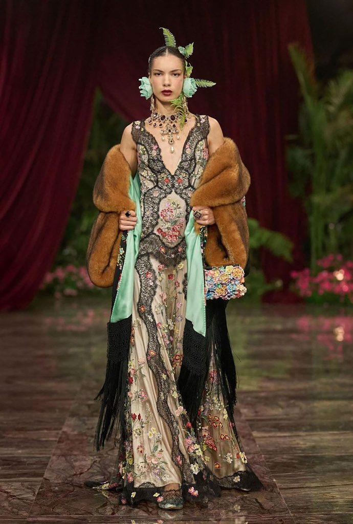 Dolce & Gabbana Alta Moda Taormina 2026 runway look featuring a fur-trimmed coat with floral embroidery, mint-green satin and black fringe.