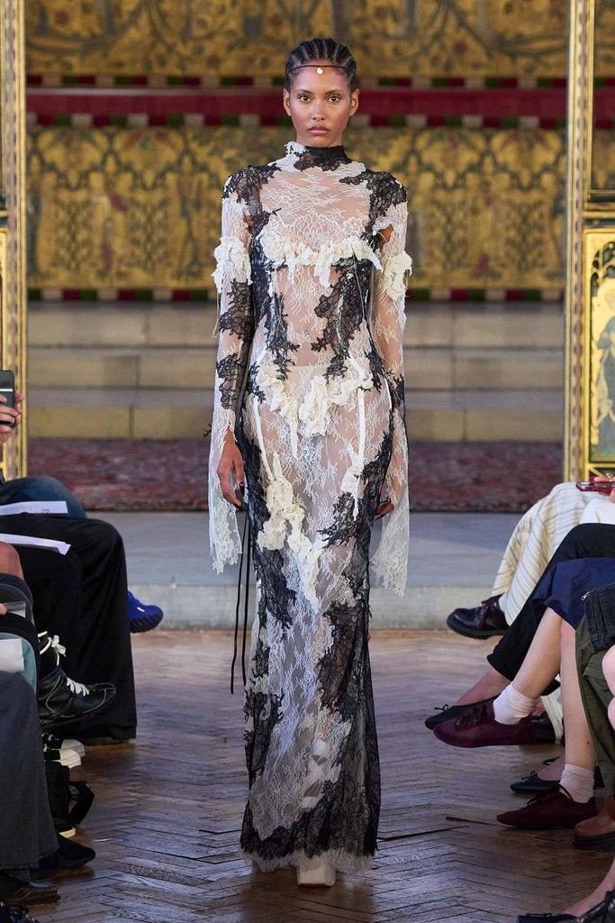 Dreaming Eli Spring 2026 runway gown with contrasting black-and-white lace and trailing fabric, worn by Poppy Delevingne at the Albies
