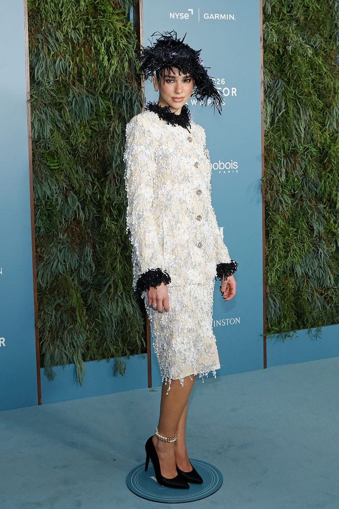 Dua Lipa wears a textured ivory Chanel Fall 2026 Haute Couture skirt suit with a black feathered hat at the WSJ. Magazine Innovator Awards in New York.