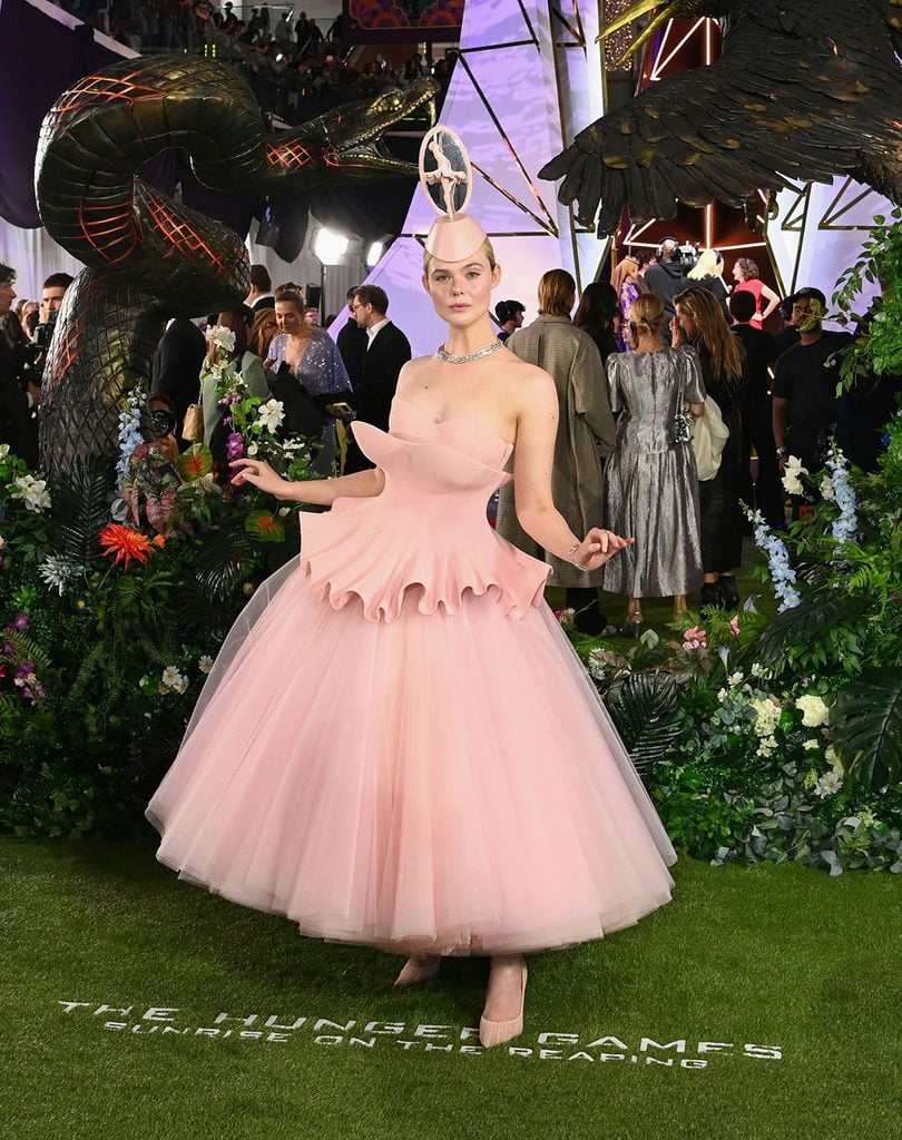 Elle Fanning wears a pink Robert Wun Fall 2026 Couture dress with a sculptural peplum, tulle skirt and ballerina headpiece at The Hunger Games: Sunrise on the Reaping London premiere.
