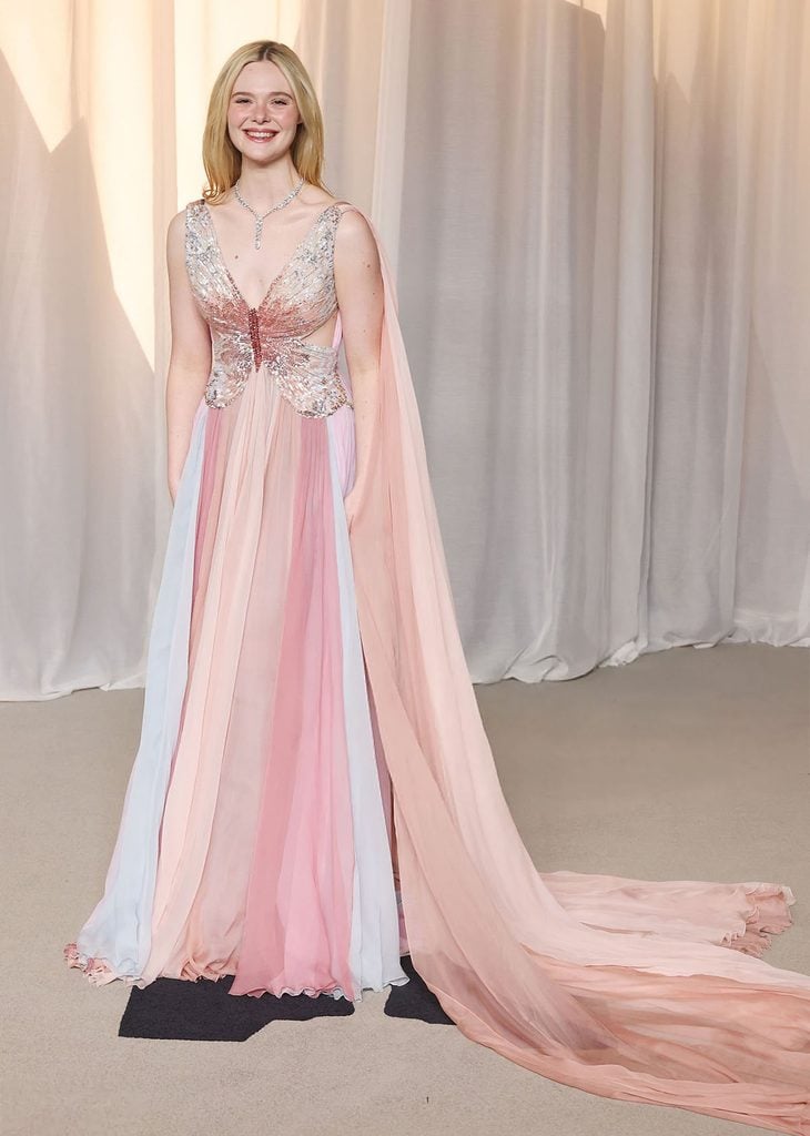 Elle Fanning wearing a pastel Valentino butterfly-inspired gown with a flowing cape at the 2026 Academy Museum Gala