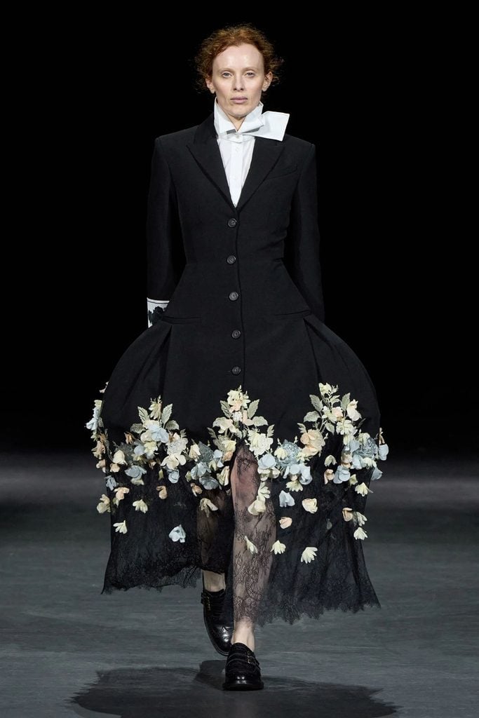 Erdem Spring 2027 runway model wearing the black floral-embroidered tailored look with a pannier-style skirt later worn by Cynthia Erivo.