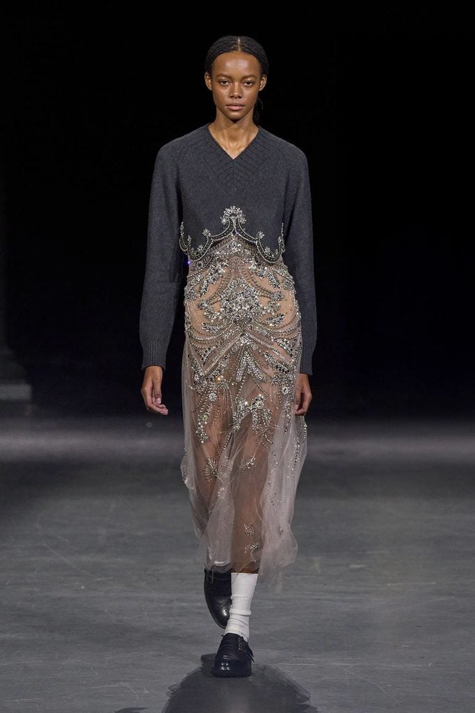 Erdem Spring 2027 runway look featuring a cropped cashmere sweater and sheer embellished dress, later worn by Keira Knightley in London.