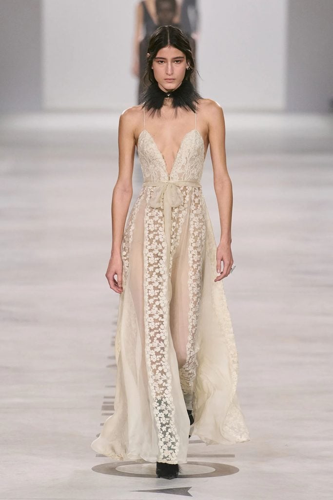Model wearing an ivory chiffon and peonia lace gown from the Fendi Fall 2026 collection on the runway.