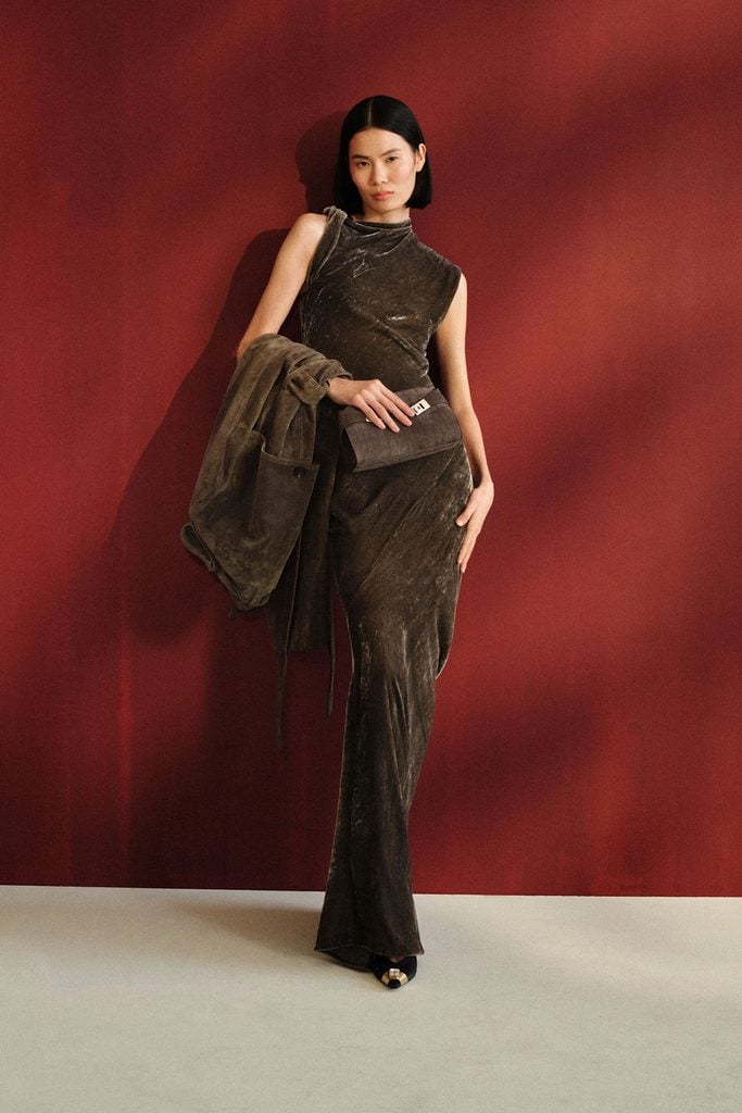 Ferragamo Resort 2027 model wearing the concrete-grey velvet dress later seen on Gemma Chan at AFI Fest.