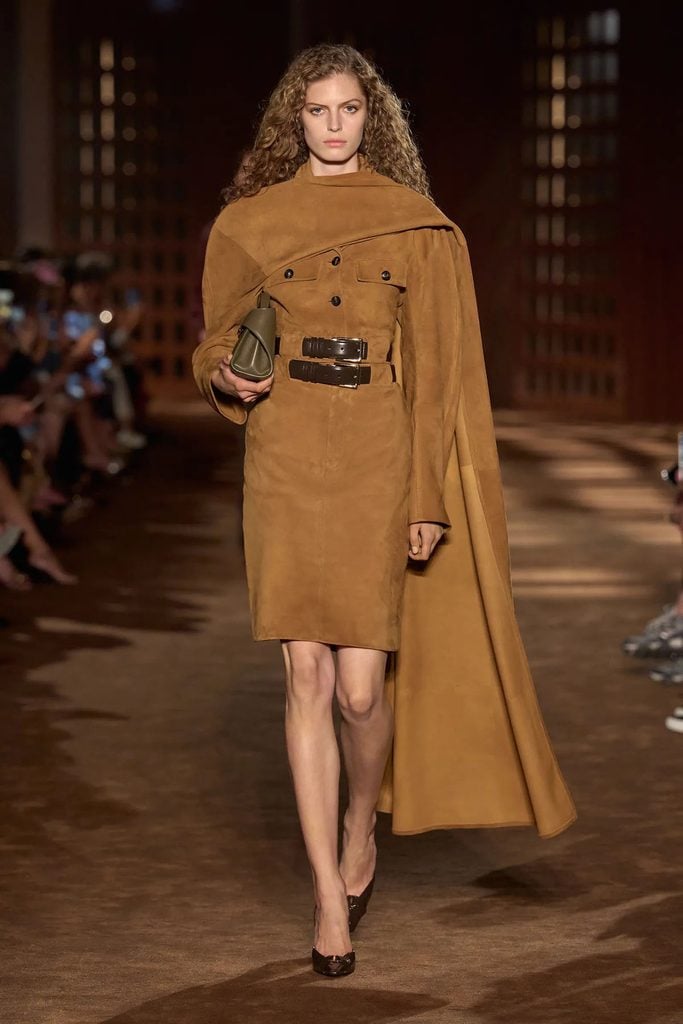 Ferragamo Spring 2027 runway model wearing the caramel suede belted jacket, matching skirt and sweeping stole later worn by Céline Dion