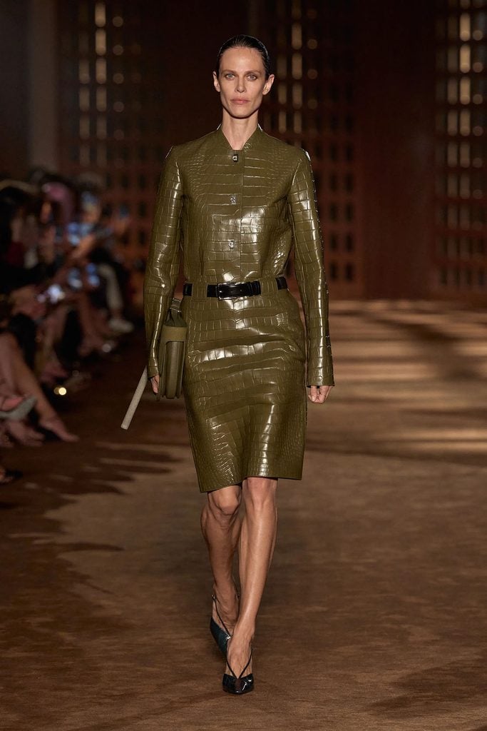 Model wearing the olive crocodile-effect jacket and matching skirt from the Ferragamo Spring 2027 collection.