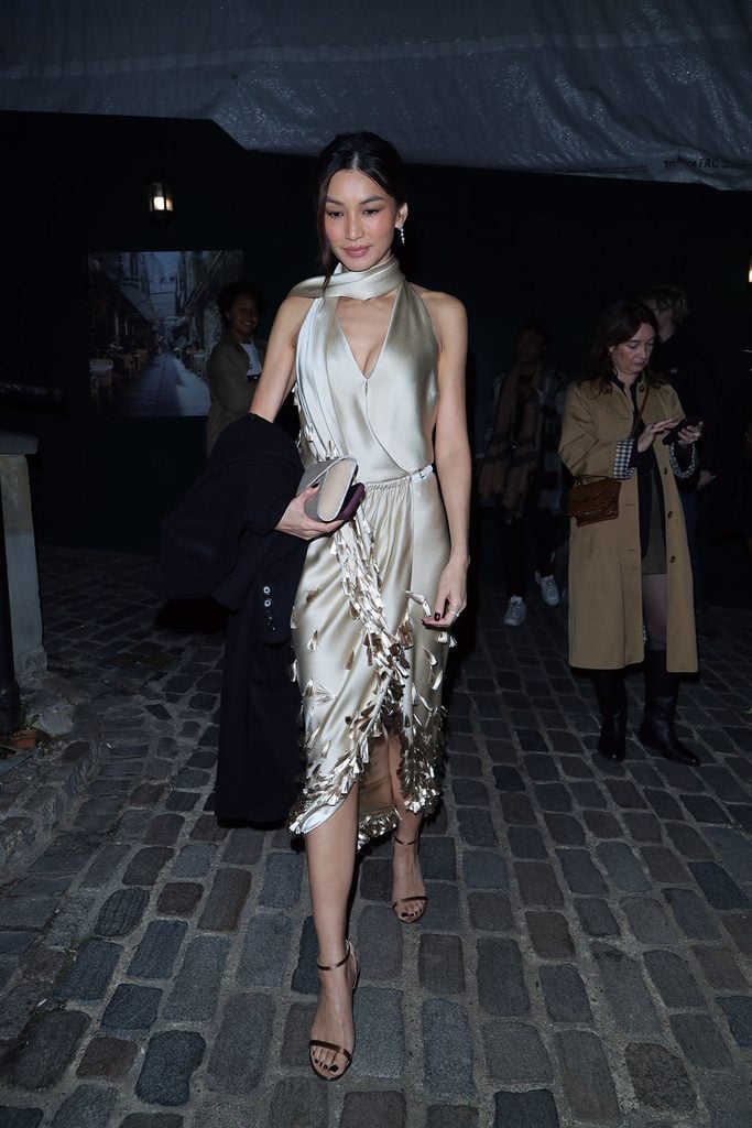 Gemma Chan in a beige Burberry Fall 2026 satin dress with scarf and tassel detailing at the Vanity Fair BFI dinner in London.