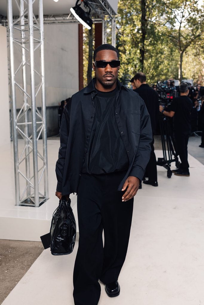 Giveon wearing an all-black Balenciaga look with sunglasses at the Spring 2027 show in Paris.