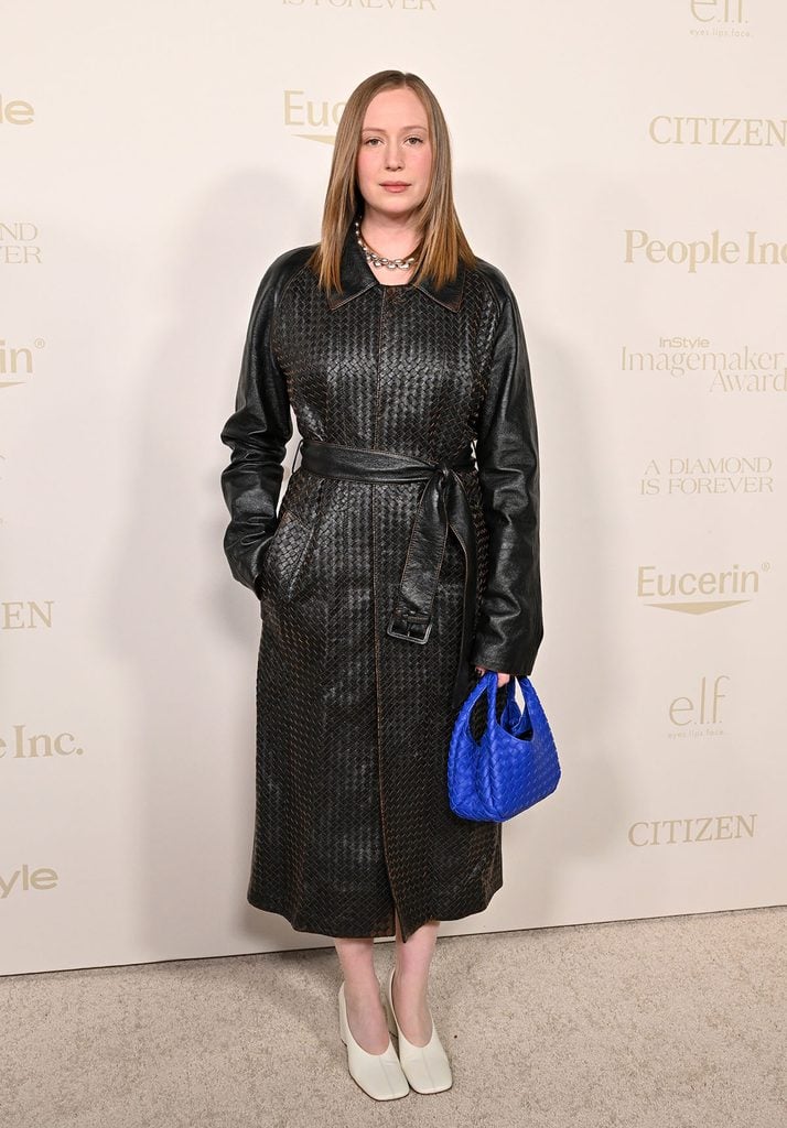 Hannah Einbinder wearing a black Bottega Veneta Fall 2026 Intrecciato leather coat with a blue Baby Campana bag at the InStyle Imagemaker Awards.