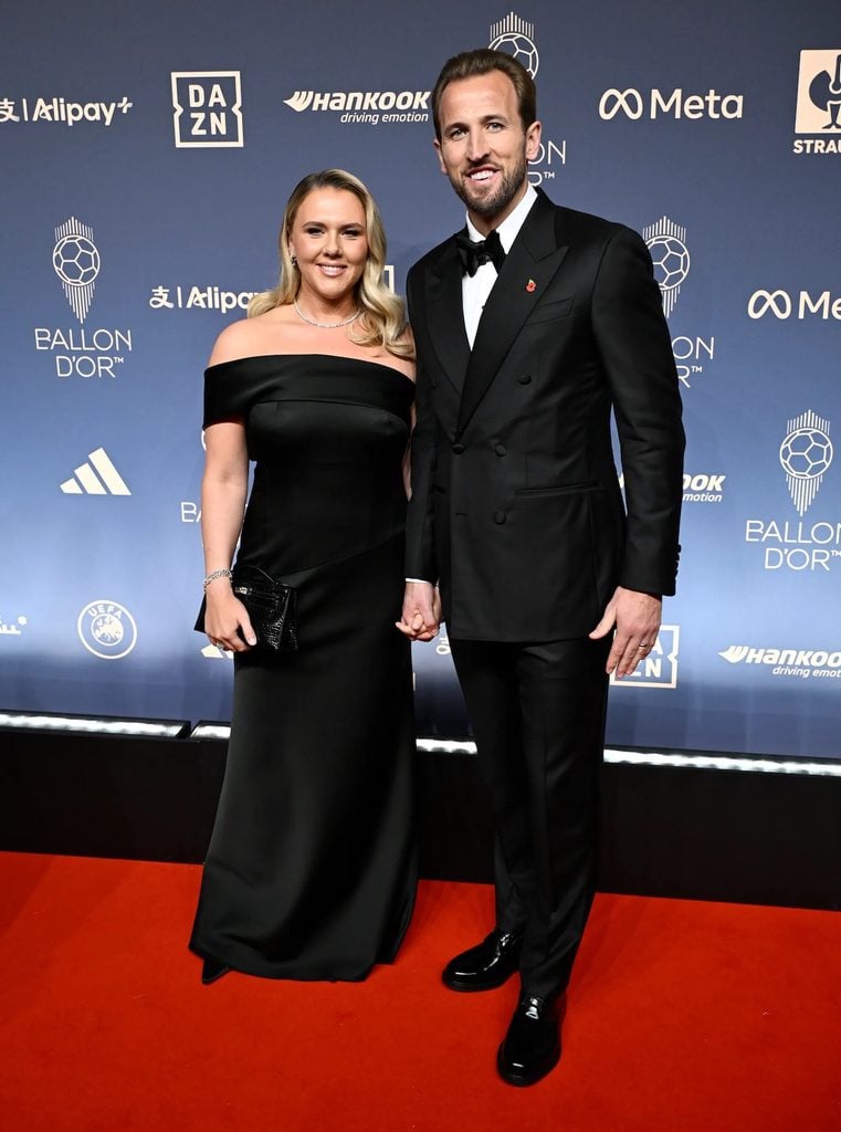 Harry Kane in a black Thom Sweeney tuxedo alongside Kate Kane in an off-the-shoulder BOSS gown at the 2026 Ballon d'Or Awards.