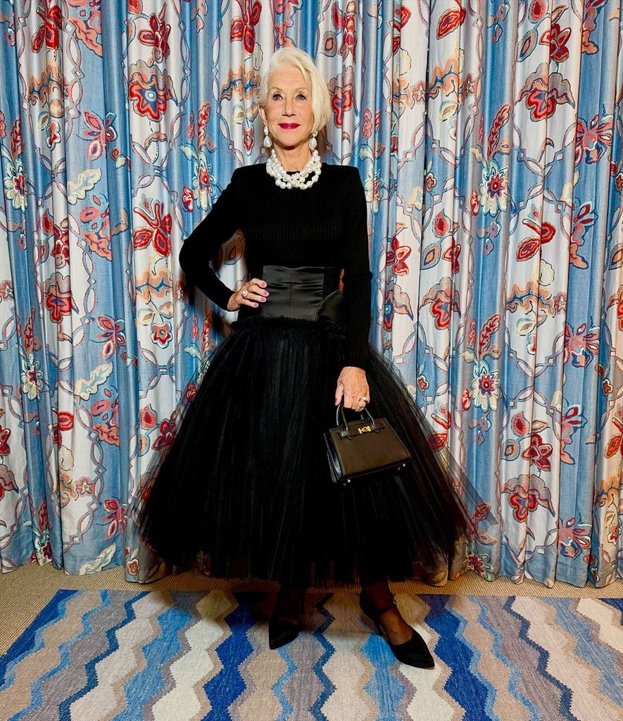 Helen Mirren in a Matières Fécales black tulle skirt, Margot McKinney pearl jewellery and carrying a Tyler Ellis Winnie handbag during the A Talent for Murder premiere celebrations.