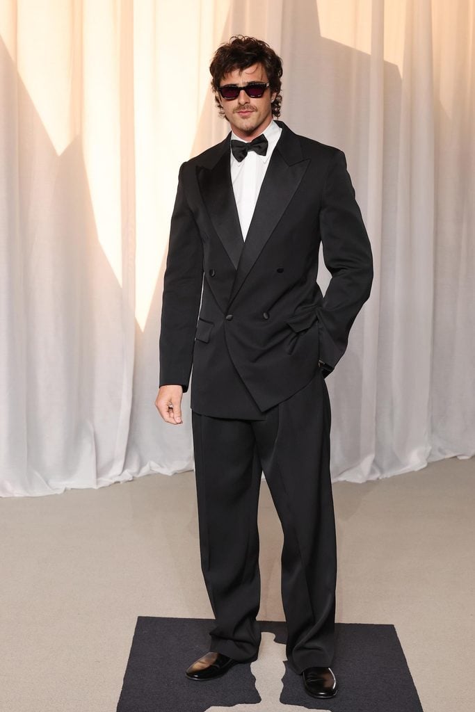 Jacob Elordi wearing a black Bottega Veneta double-breasted tuxedo and sunglasses at the 2026 Academy Museum Gala.