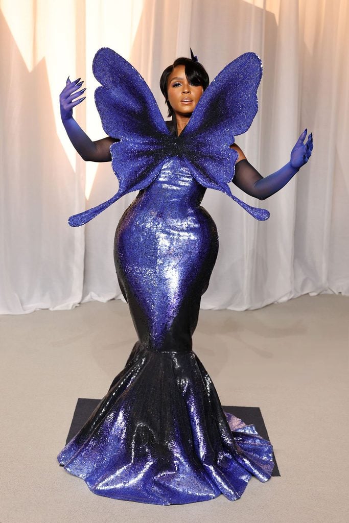 Janelle Monáe in a purple Robert Wun butterfly-inspired Couture gown with oversized wings at the 2026 Academy Museum Gala