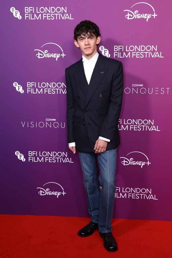 Joe Locke in a Givenchy by Sarah Burton navy double-breasted jacket with jeans and Chelsea boots at the 'Vision Quest' BFI London Film Festival premiere.