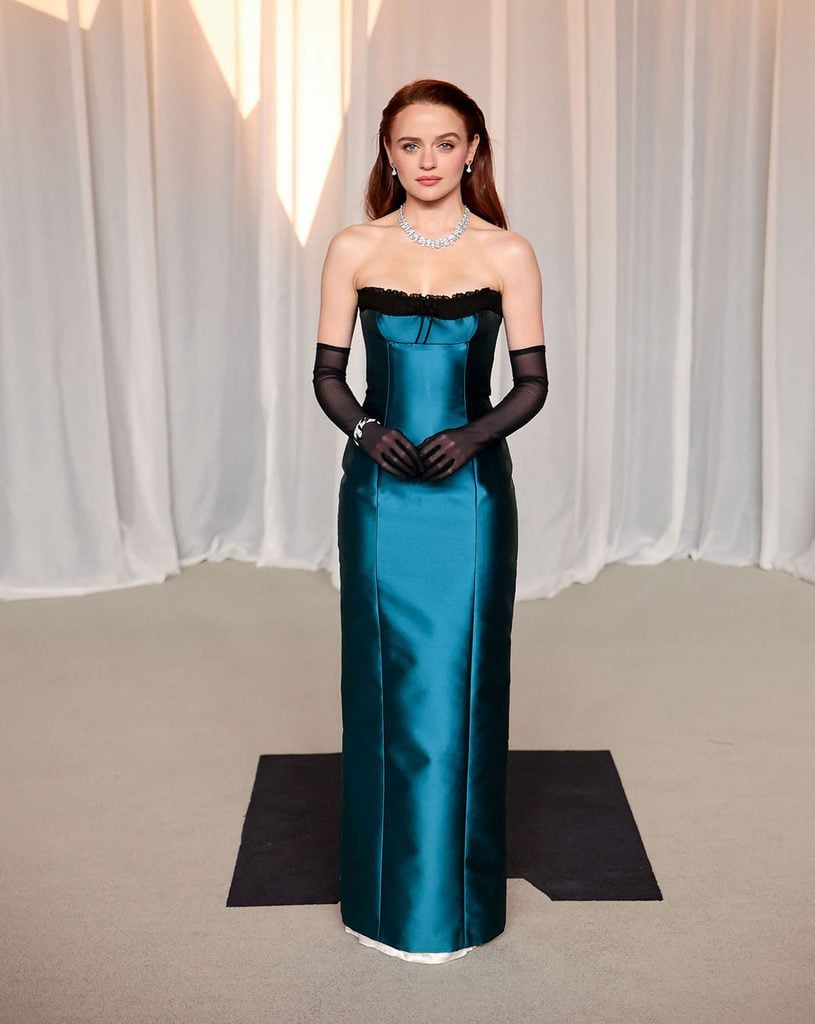 Joey King in a teal satin custom Miu Miu gown with black tulle gloves at the 2026 Academy Museum Gala in Los Angeles