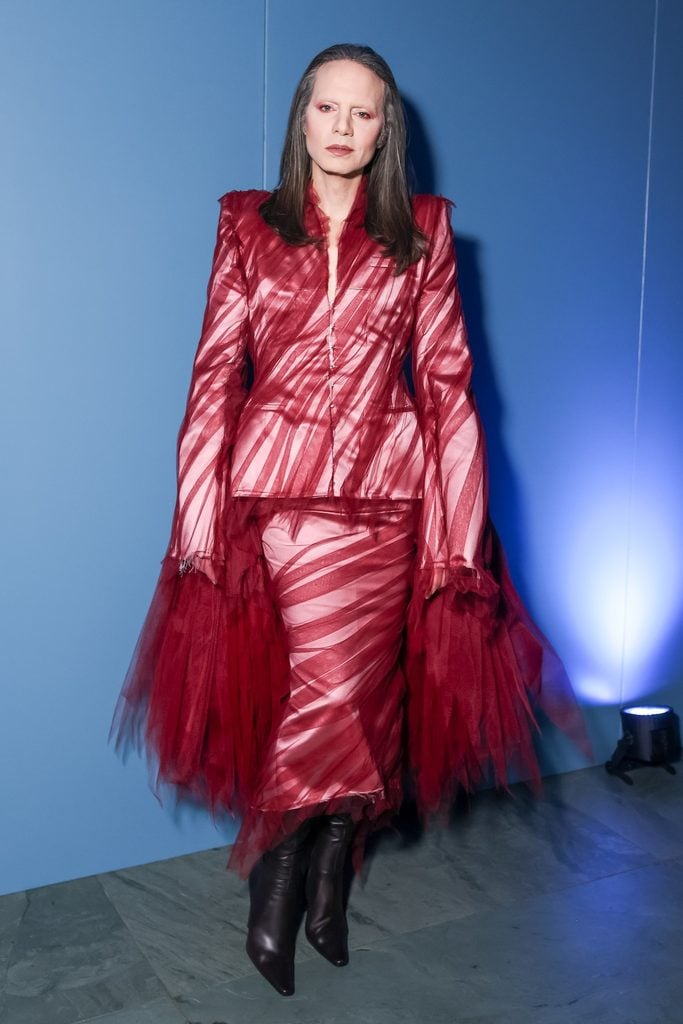 Jordan Roth wearing a sheer red Matières Fécales Spring 2026 tailored ensemble with layered tulle and black boots at the WSJ. Magazine Innovator Awards.