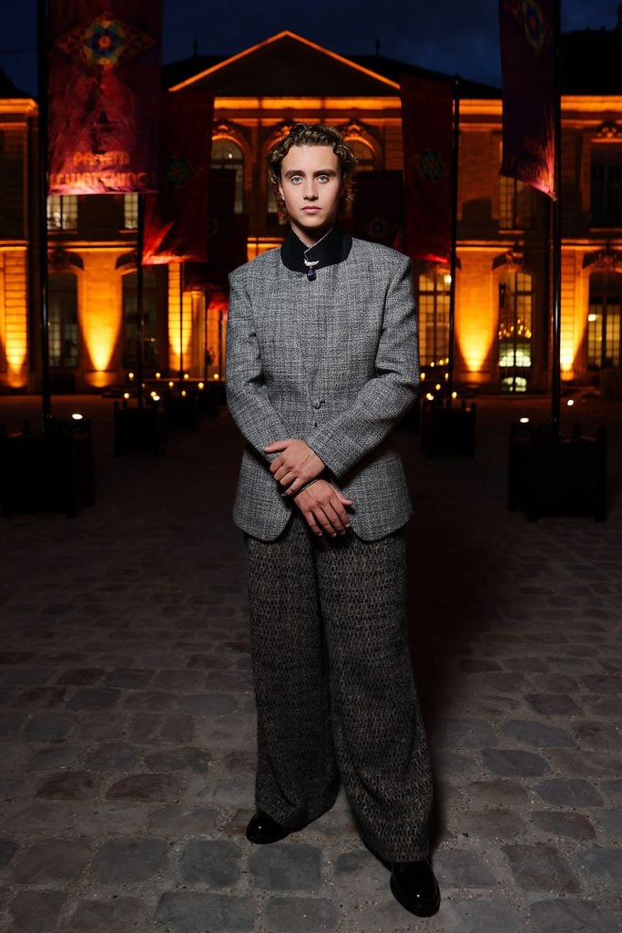 Joseph Zada in an ERL suit featuring a turned-up black collar at Musée Rodin in Paris.