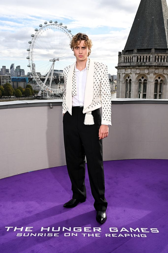 Joseph Zada wears a crystal-embroidered ivory TOM FORD by Haider Ackermann cropped jacket with black trousers at The Hunger Games: Sunrise on the Reaping London photocall.