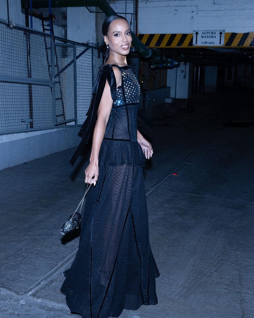 Kerry Washington wearing Lanvin Pre-Fall 2026 with velvet shoulder ties and a Judith Leiber clutch.