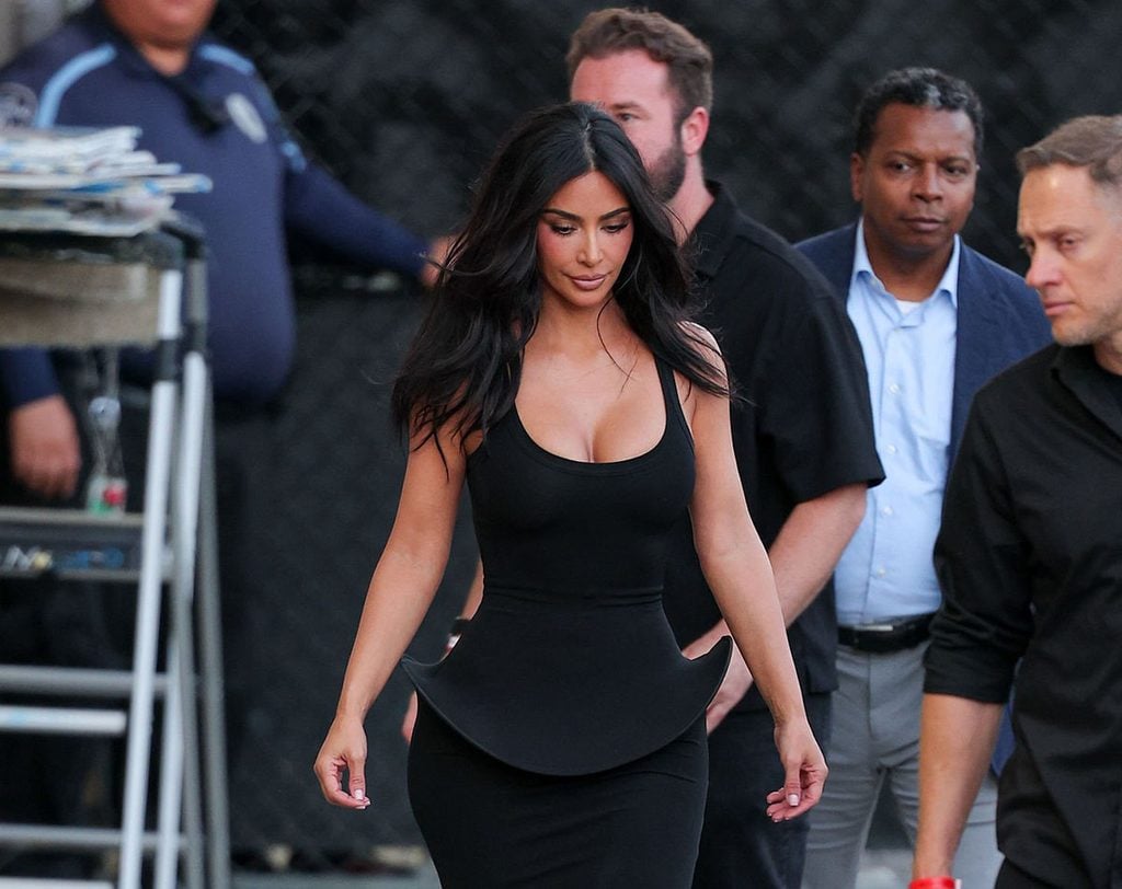 Side view of Kim Kardashian in a grey Sportmax dress with a curved peplum detail outside ABC Studios in Los Angeles
