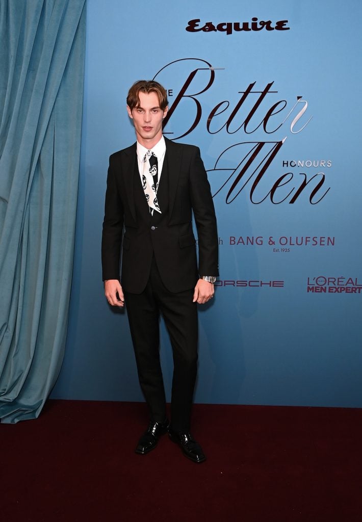 Kit Butler wearing a black McQueen suit with a skull-print tie at Esquire UK's Better Men Honours in London.