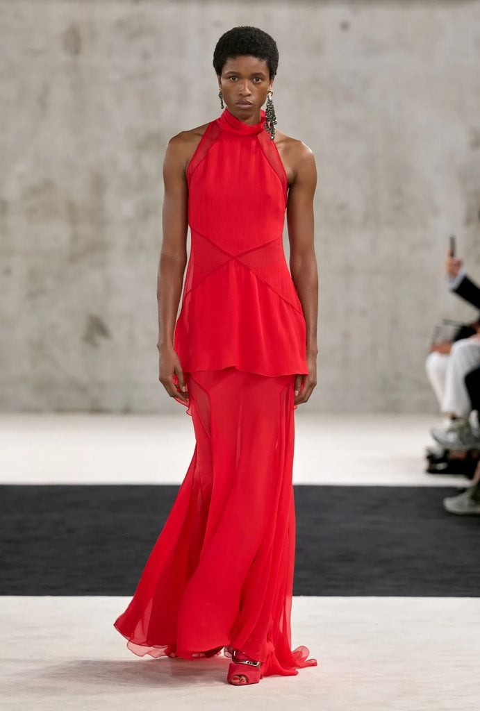 Lanvin Spring 2027 runway model wearing the red halterneck panelled dress by Peter Copping, later worn by Sofia Carson at the 2026 TIME Latino Leaders celebration.