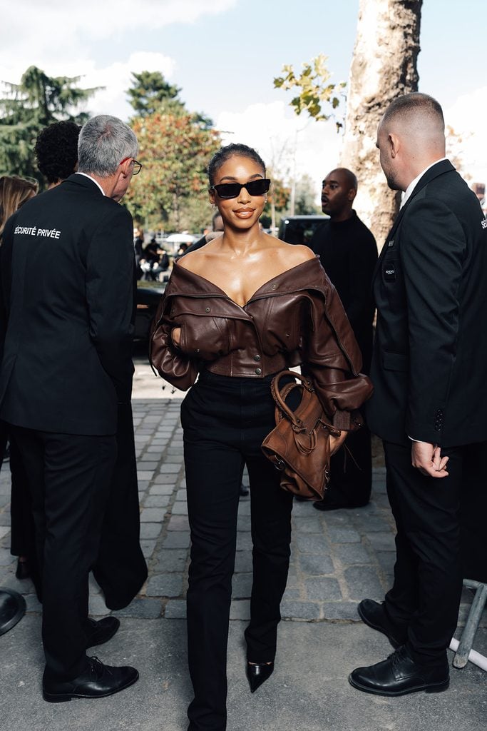 Lori Harvey wearing a brown Balenciaga leather jacket with black trousers and carrying a City bag in Paris.