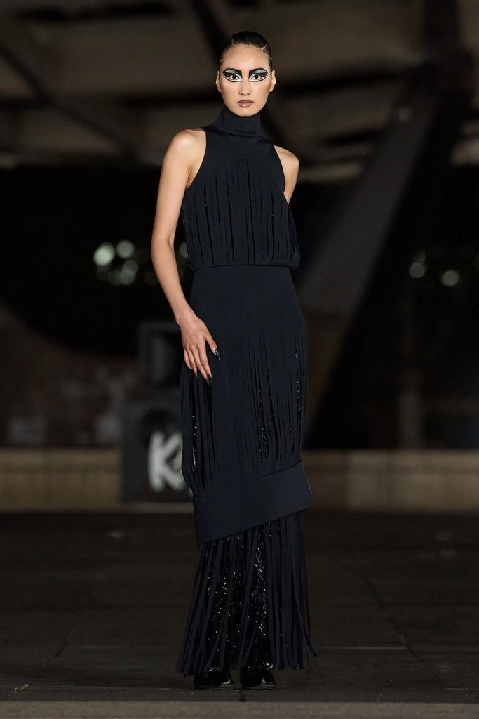 Luar Fall 2026 black halter dress with slashed embellishment and fringed detailing on the runway.