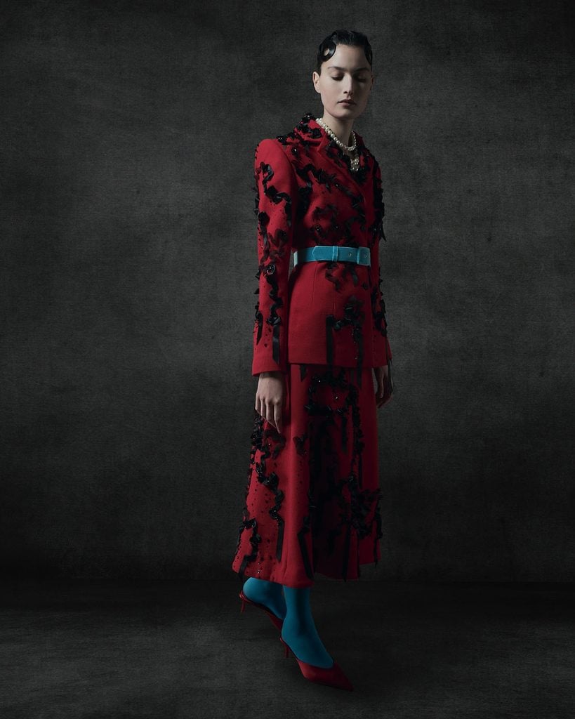 Lurline red ribbon-embellished jacket and skirt styled with a turquoise belt and tights, as worn by Billie Piper at the 2026 SCAD Savannah Film Festival.