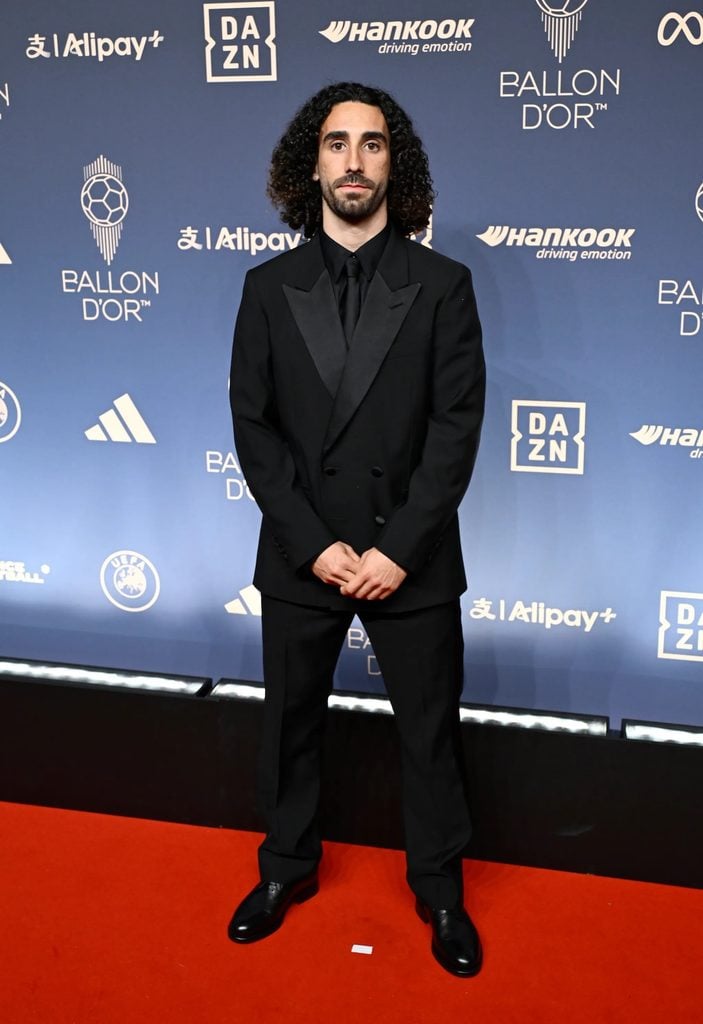 Marc Cucurella wearing a black Louis Vuitton double-breasted suit with satin peak lapels at the 2026 Ballon d'Or Awards.