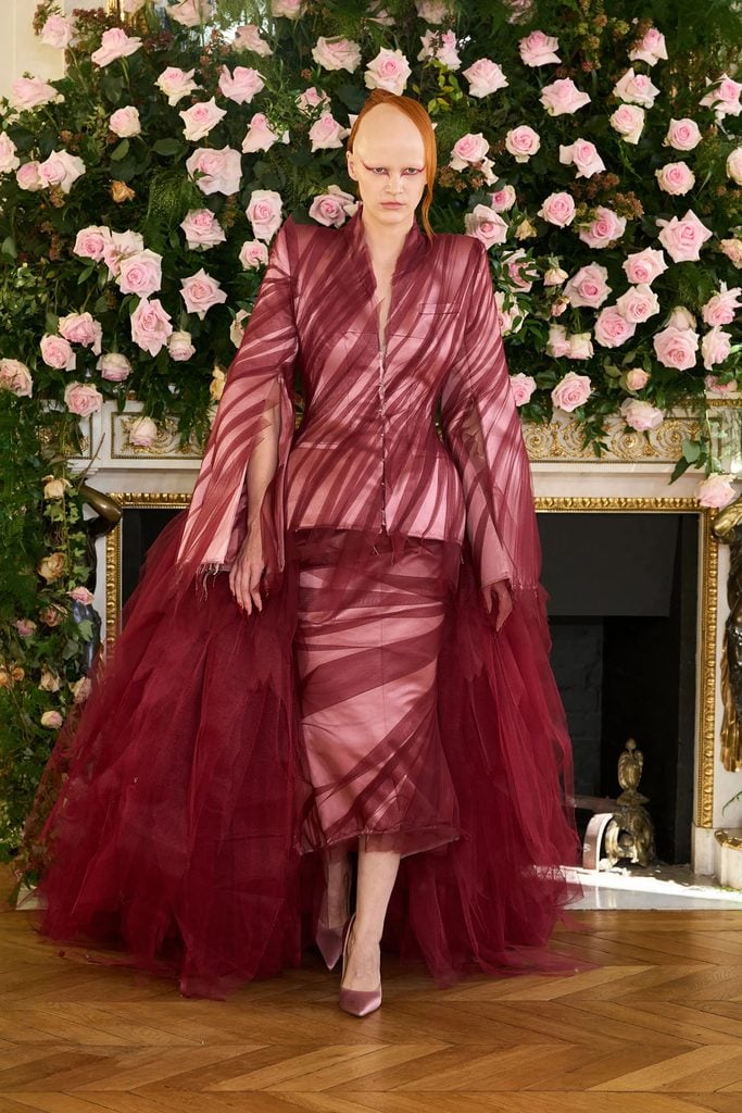sheer red Matières Fécales Spring 2026 tailored ensemble with layered tulle and black boots