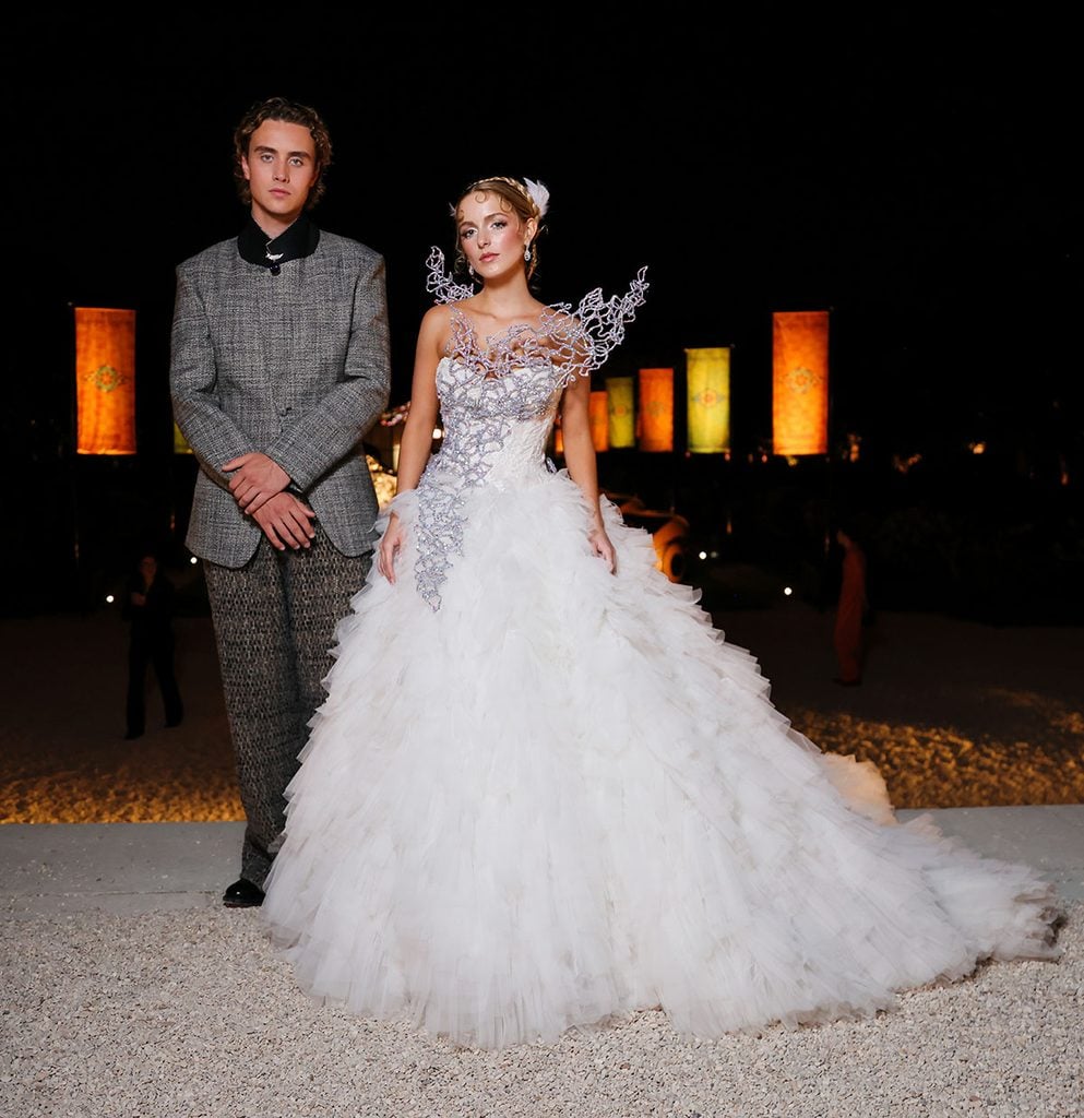Mckenna Grace in Monique Lhuillier with Joseph Zada in ERL at The Hunger Games event in Paris.