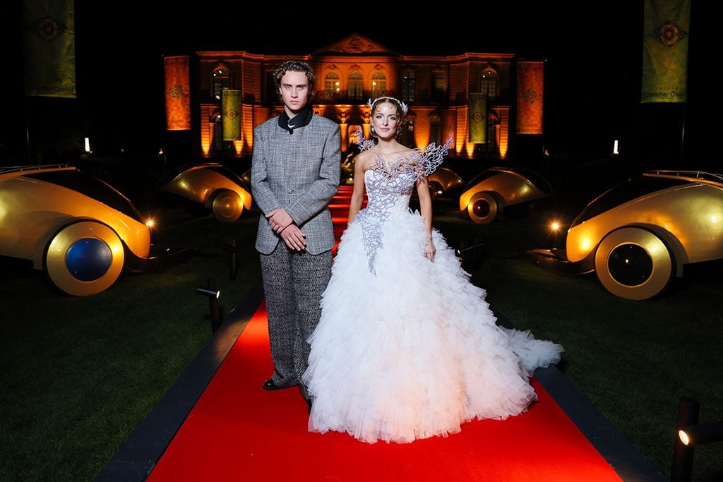 Mckenna Grace wearing Monique Lhuillier alongside Joseph Zada in ERL at the Hunger Games Elegance Is Authority event.
